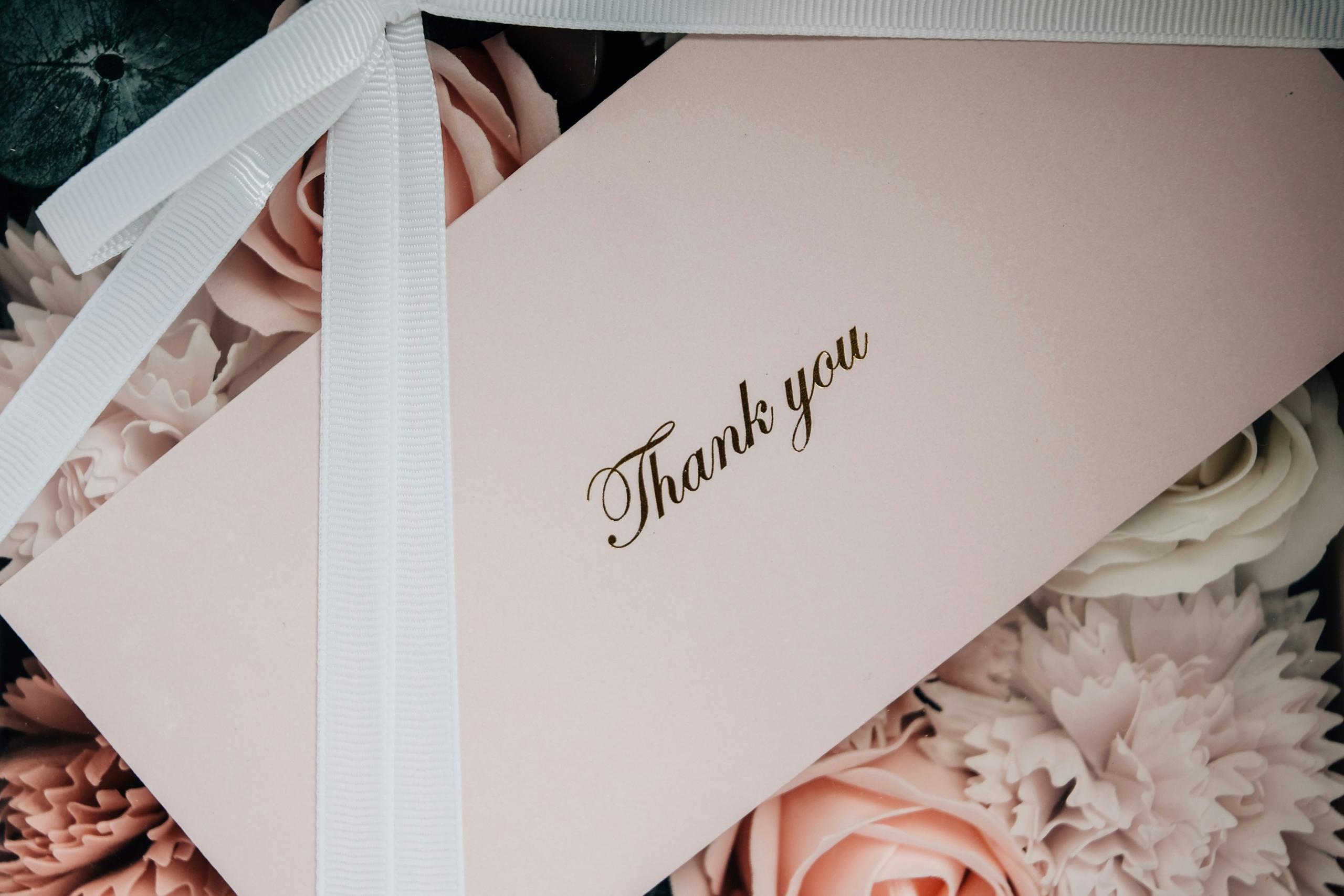 A thank you card and flower.