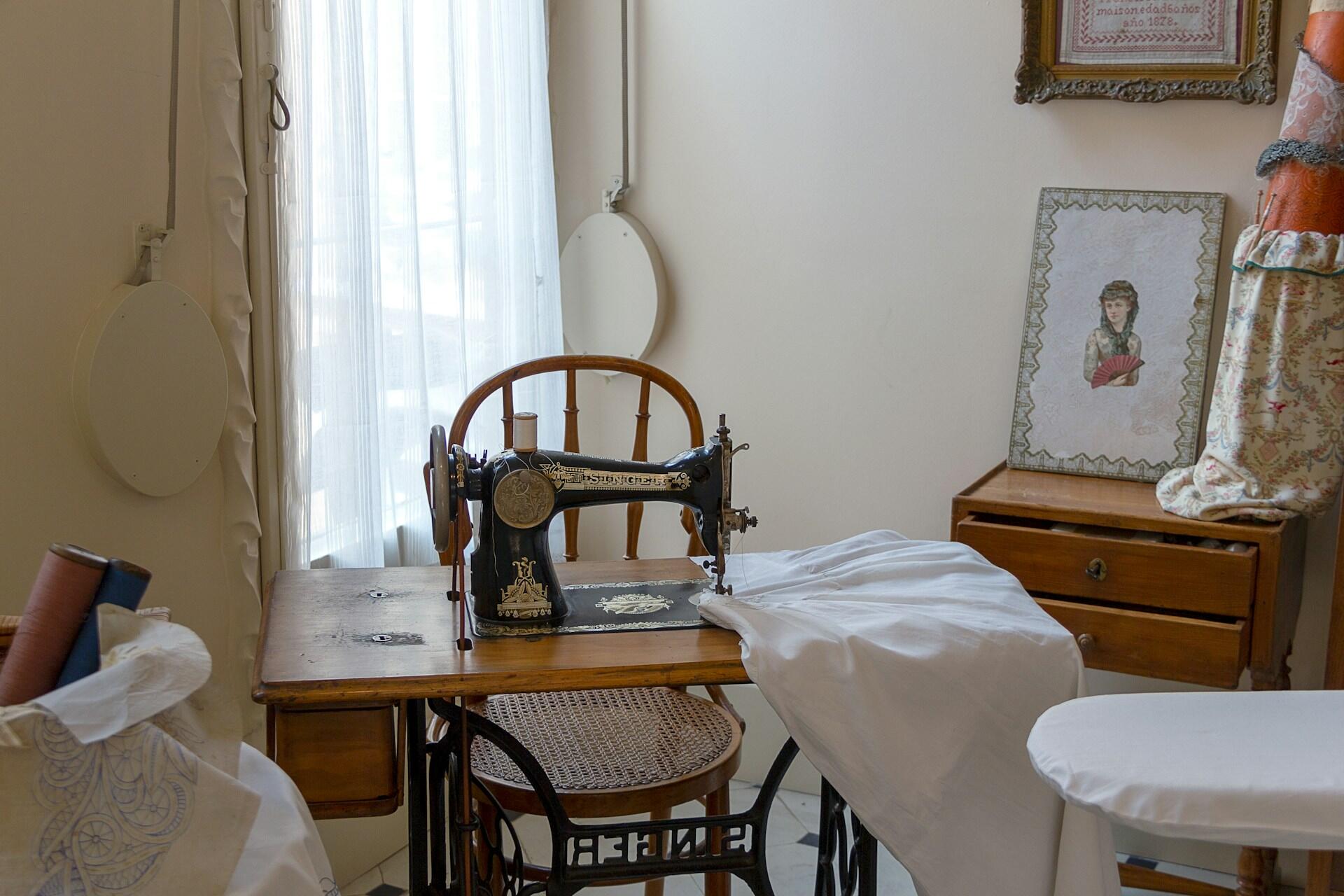A sewing machine with a white fabric locked in.