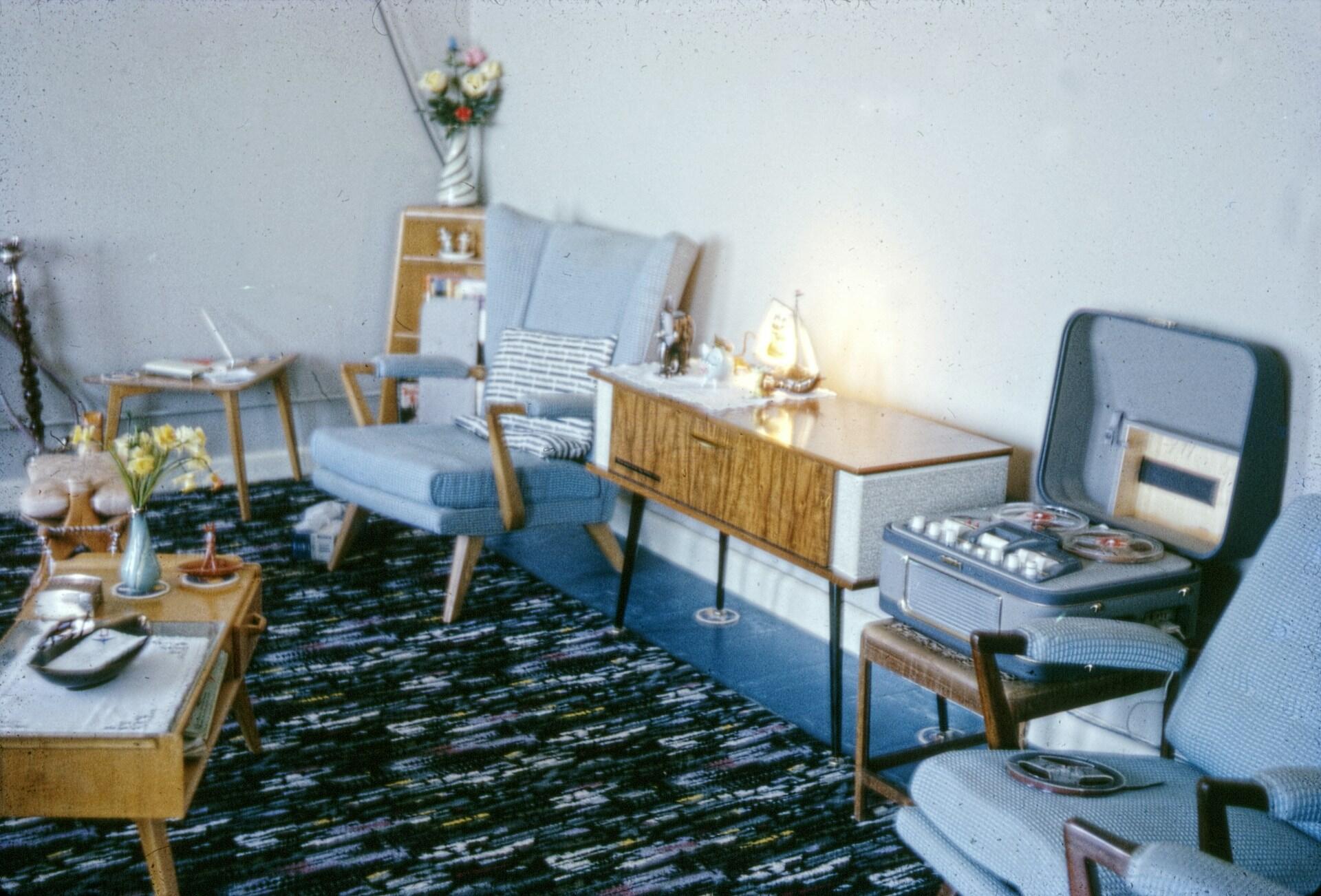 A sitting area with two chairs and tables.