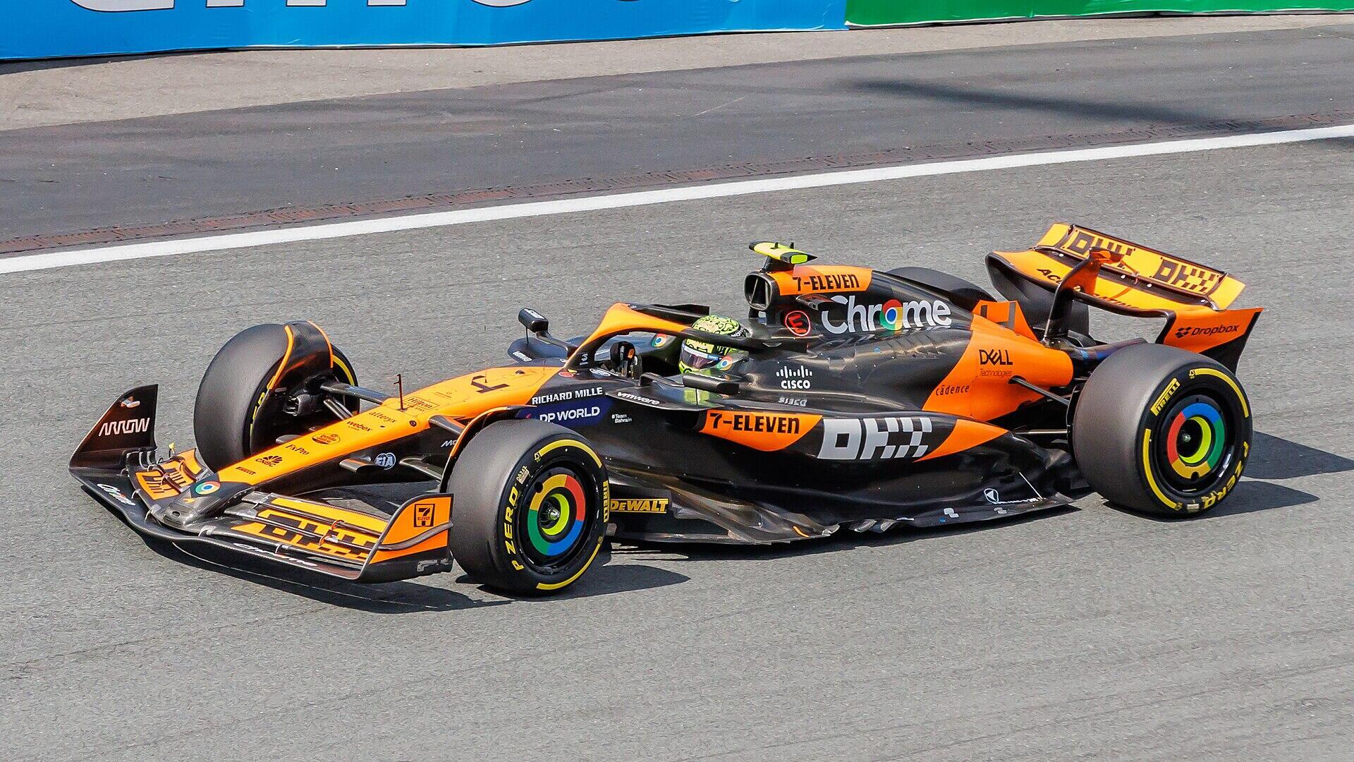 orange racing car on a racetrack.